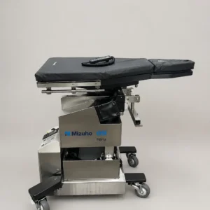 Mizuho OSI Hana Table REF 6875 orthopedic fracture table with powered height adjustment, lateral tilt, and hand control remote for hip and lower extremity surgery.