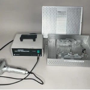 Zimmer Electric Dermatome Complete Kit 8821-00 with dermatome handpiece, power supply, autoclave case, width plates, and screwdriver for split-thickness skin graft harvesting.